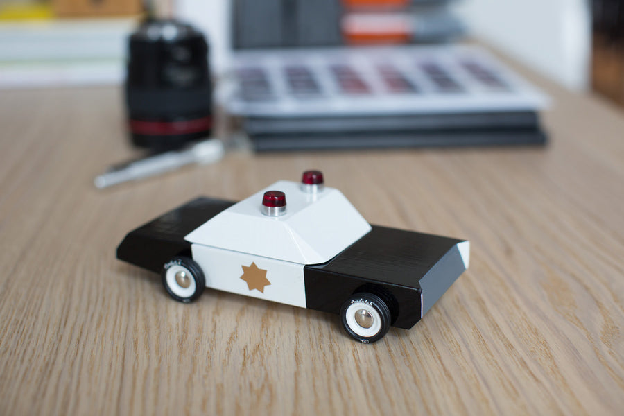 Candylab childrens police cruiser collectable toy on a wooden desk