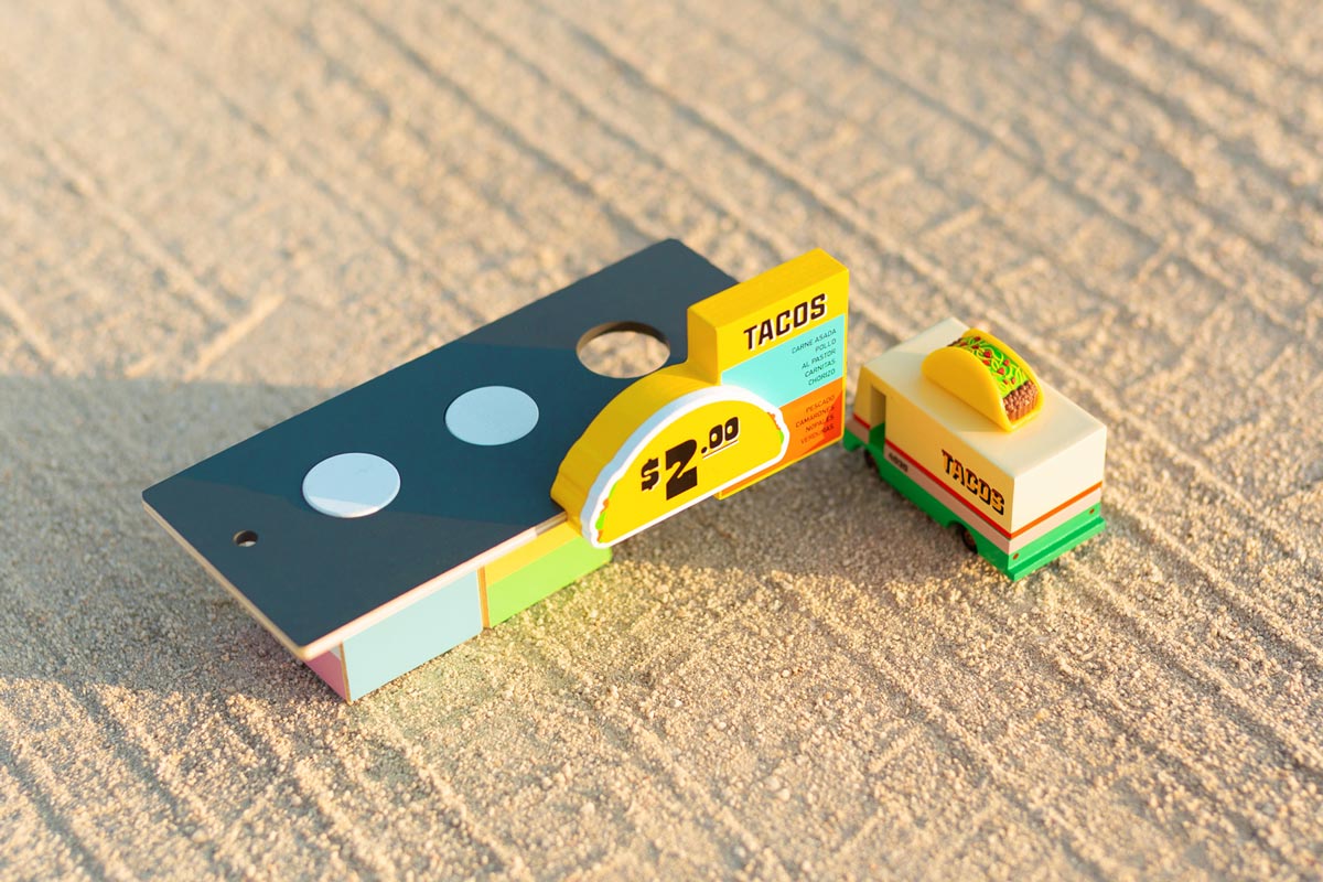 Candylab kids wooden taco van and taco shack toys on a sandy background