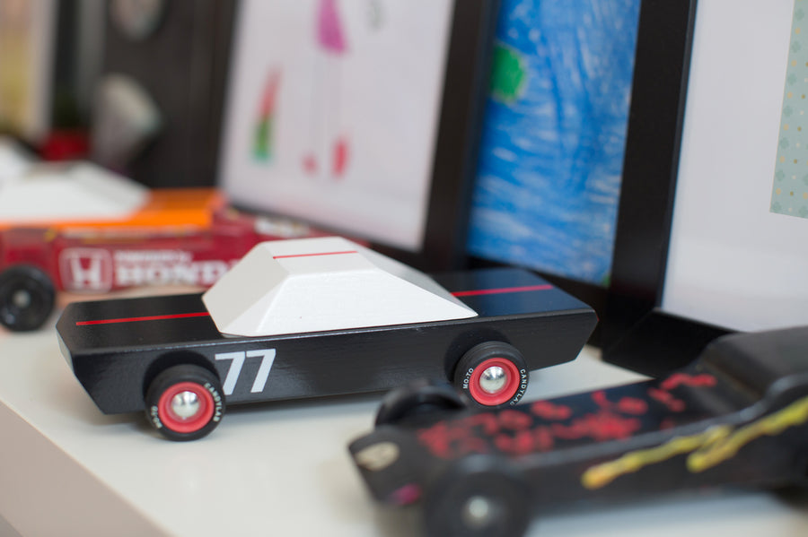 Back of the Candylab plastic-free wooden Carbon 77 racing car toy on a white background