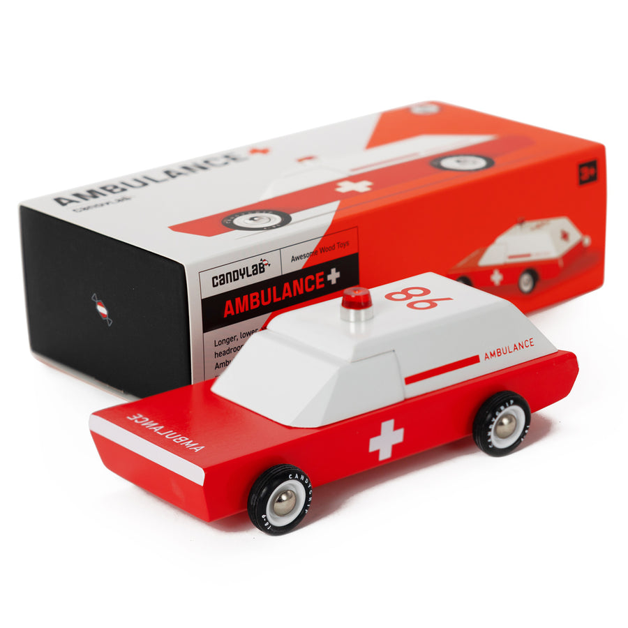 Candylab children's wooden toy ambulance on a white background next to its cardboard box