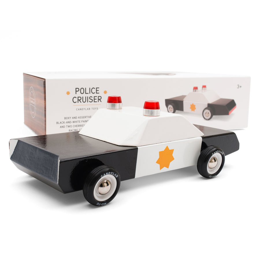 Candylab childrens solid wooden Police cruiser car toy on a white background in front of its cardboard box