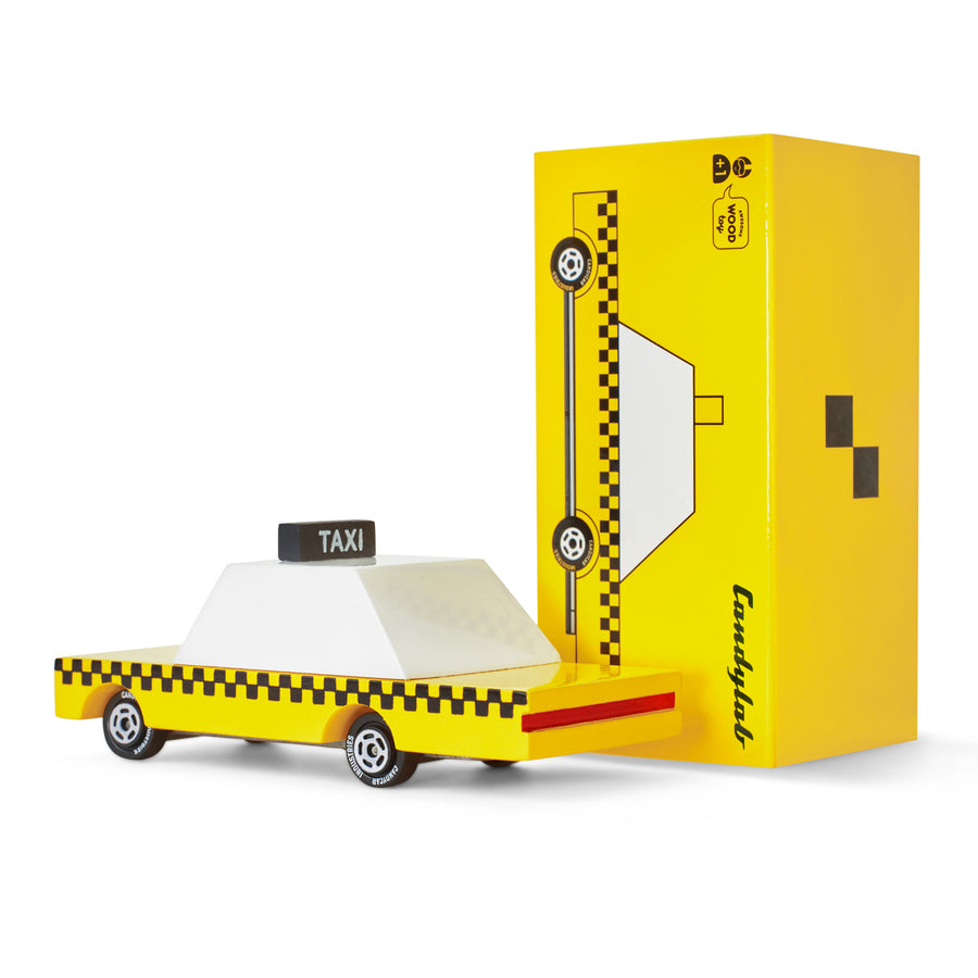 Candylab candycar wooden taxi toy on a white background next to its yellow cardboard box