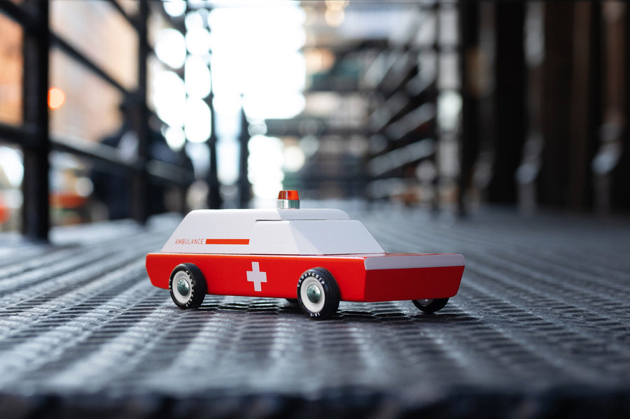 Close up of the Candylab wooden ambulance car on a metal floor