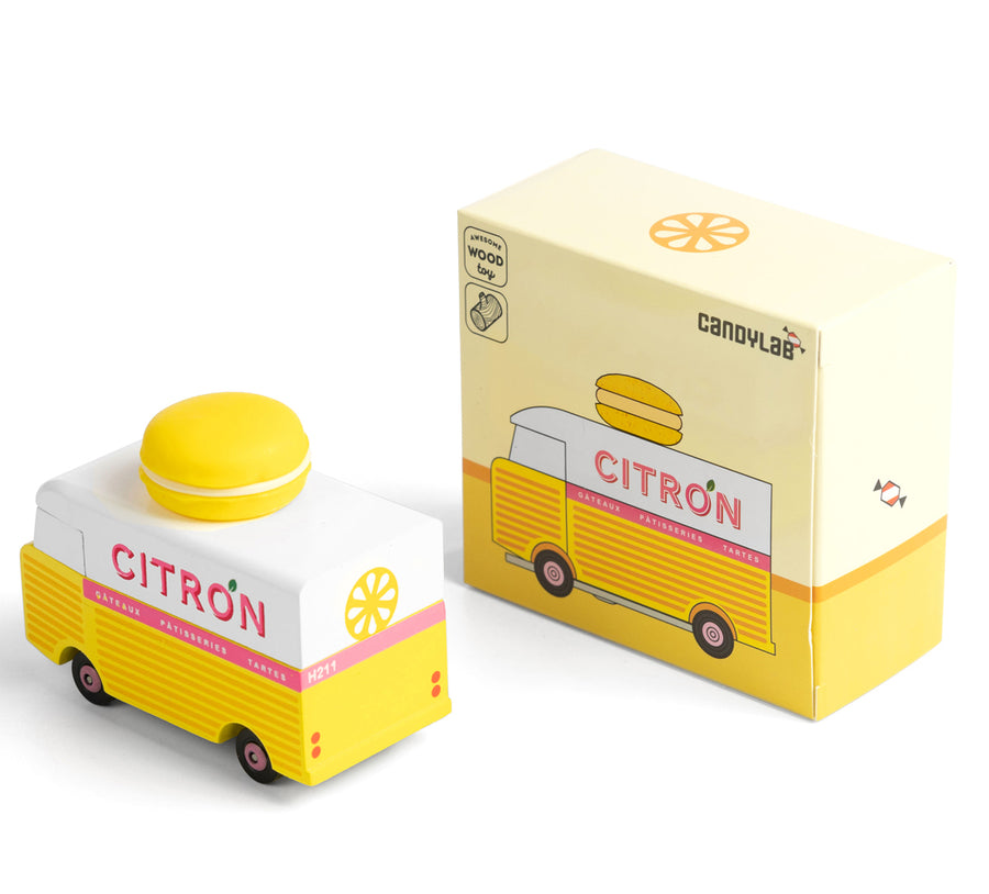 Picture of the Citron Candylab Candyvan with its box. It is a 1960s style yellow and white van with a yellow Lemon Macaron on the roof.