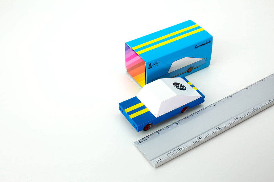 Candylab candycar blue racer 8 toy on a white background next to its box and a metal ruler