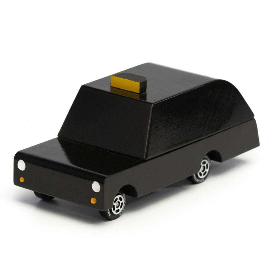 Side of the Candylab plastic-free wooden London taxi toy on a white background