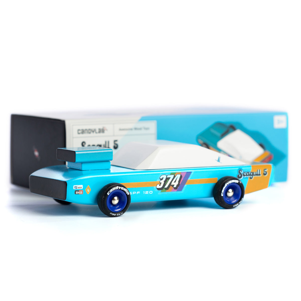 Candylab collectable wooden seagull racing car toy on a white background next to its box