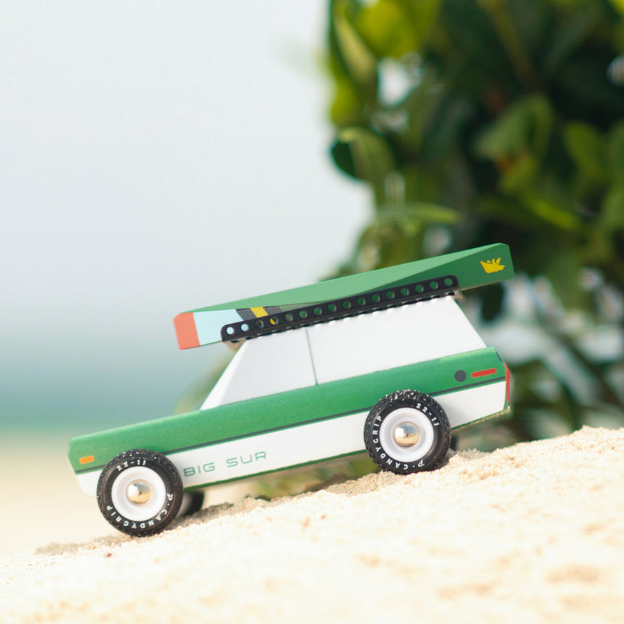 Picture of the magnetic wooden canoe boat toy attached to a Candylab Big Sur toy car.