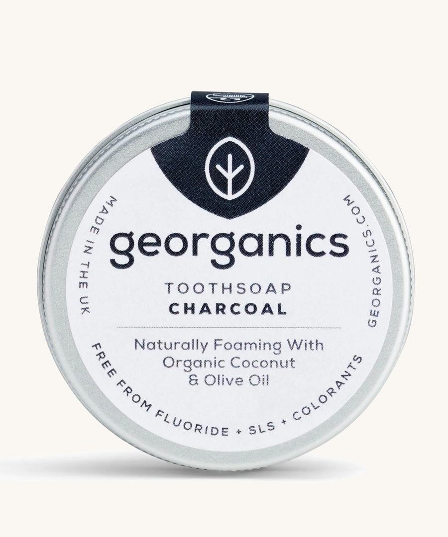 A tin of the Georganics charcoal toothsoap on a cream background