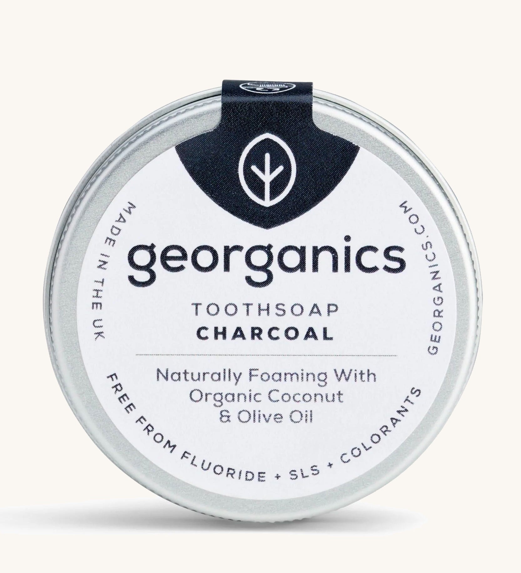 A tin of the Georganics charcoal toothsoap on a cream background