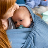 Close up of a baby in the close caboo lite denim blue baby carrier