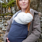 Close up of smiling baby inside the close caboo organic baby carrier in the blueberry colour