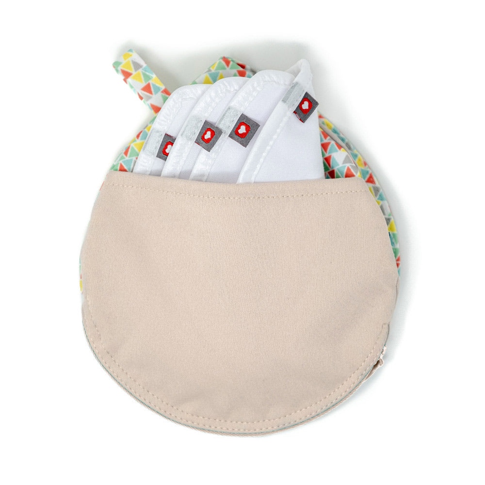 4 Close reusable maternity breast pads inside the pastel print breast pad pouch on a white background