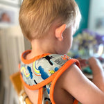 Close popin toucan sleeveless bib modelled by toddler