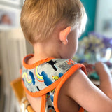 Close popin toucan sleeveless bib modelled by toddler