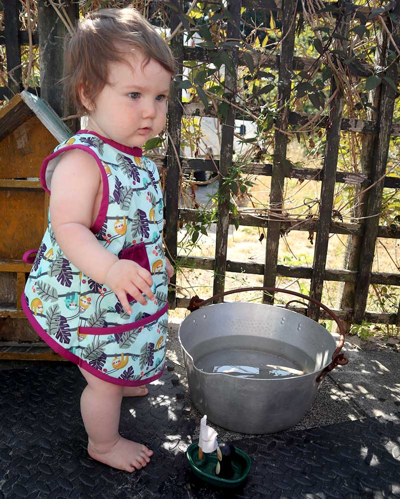 Close popin sloth sleeveless bib modelled by toddler