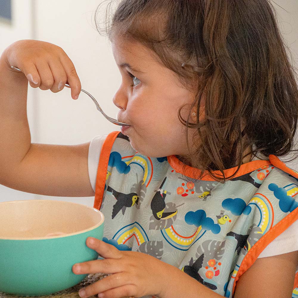 Close popin toucan sleeveless bib modelled by toddler