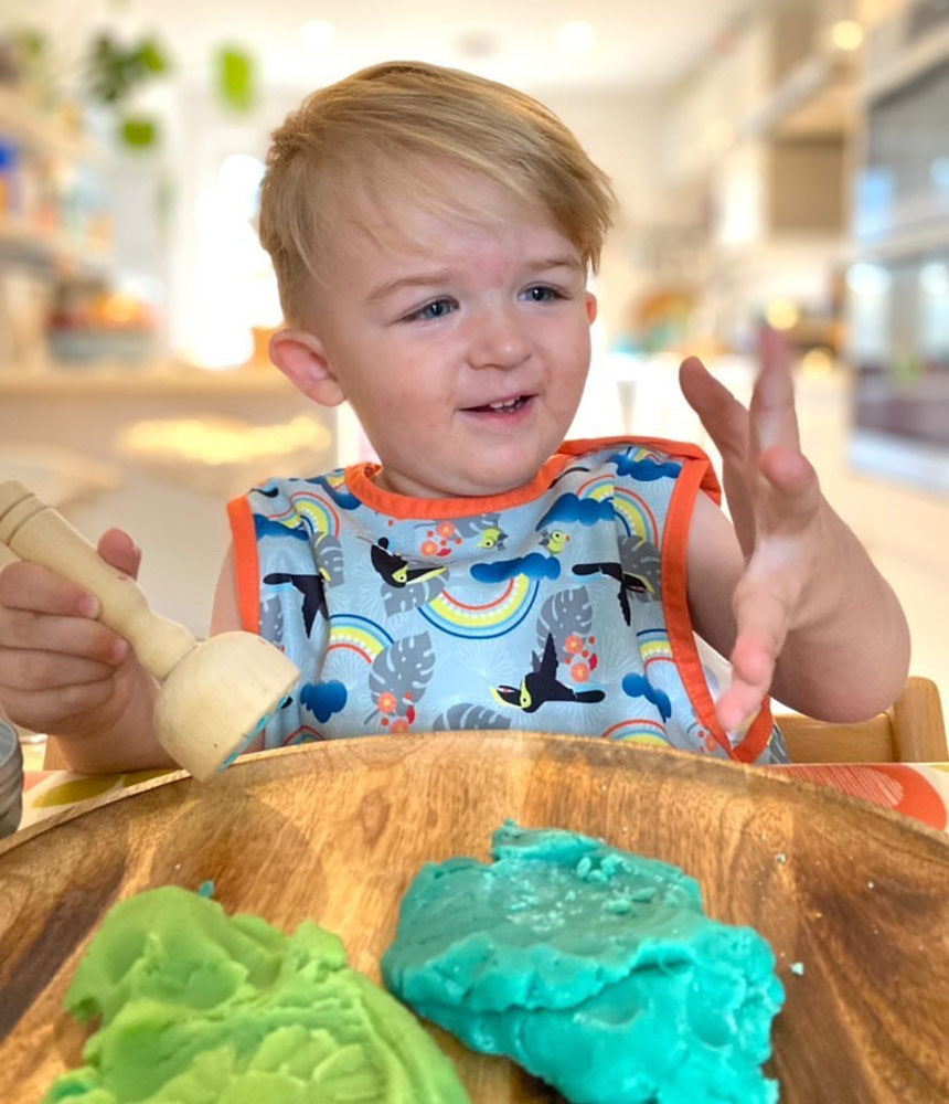 Close popin toucan sleeveless bib modelled by toddler