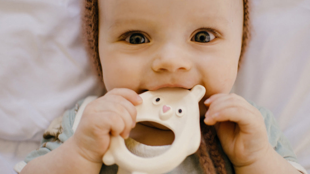 Baby chewing a Cloud and Cuckoo natural rubber teether