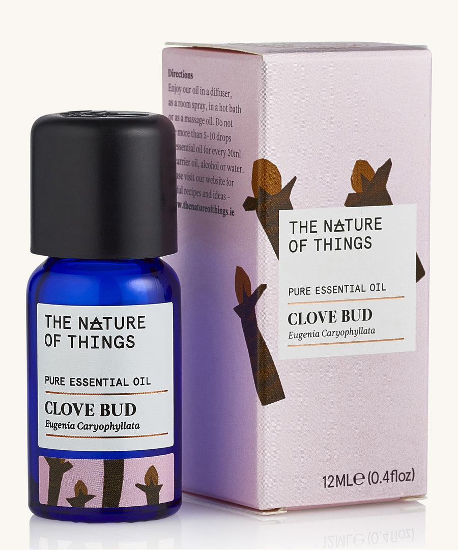 Organic Clove Bud pure essential oil in a blue glass bottle in front of a decorative pink cardboard box.