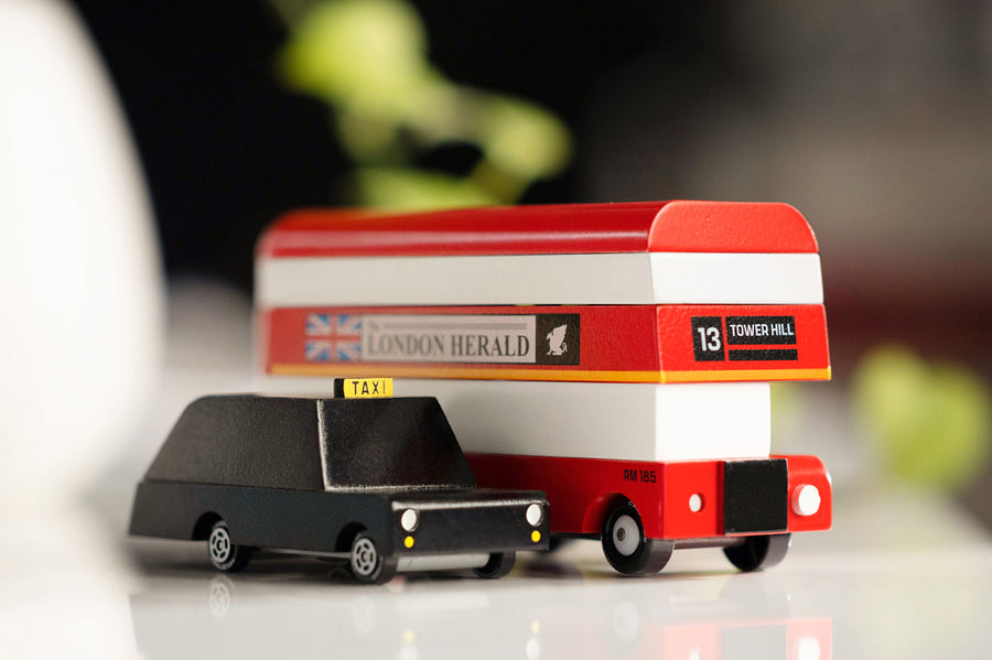 Close up of the Candylab wooden London Bus and London Taxi toys on a white background