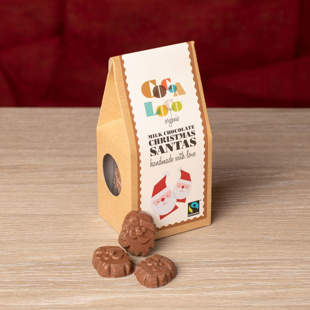 Box of Organic Cocoa Loco festive Santa Claus chocolates on a wooden table next to a red background