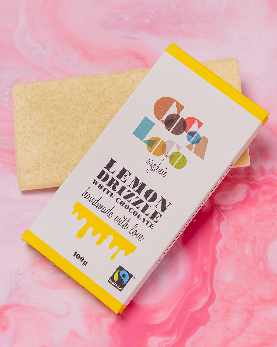 Cocoa Loco Organic Fairtrade Eco-Friendly White Chocolate Lemon Drizzle Bar laying underneath the packaging box