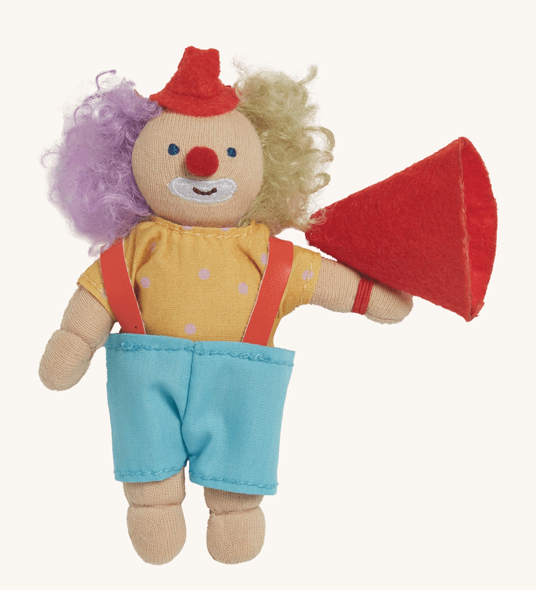 Olli Ella Holdie Folk Confetti The Clown. A fun clown figure with purple and blonde hair, a little red hat, a yellow top with white spots and light blue shorts, with a red fabric megaphone, on a cream background