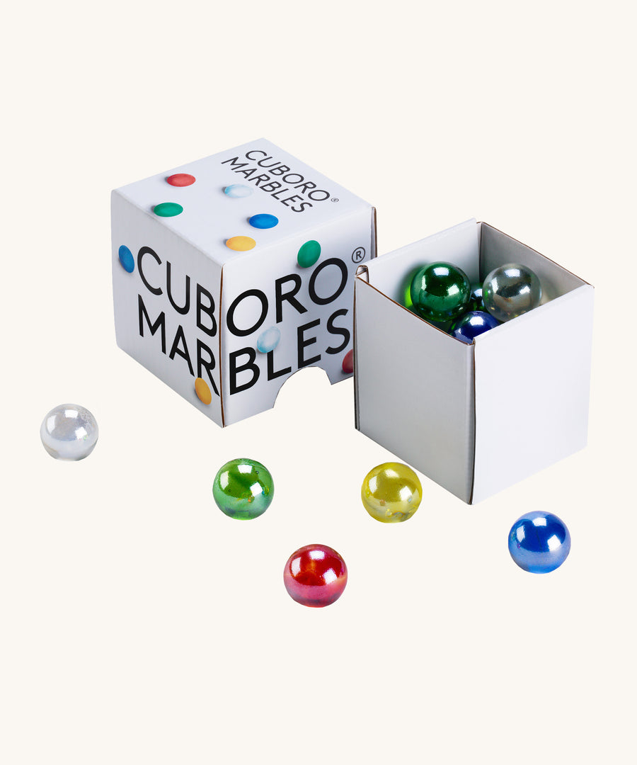 Cuboro 15 coloured glass marbles in their cardboard box on a cream background