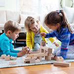 3 children playing with the Cuboro plastic-free wooden marble run toy set on a blue carpet