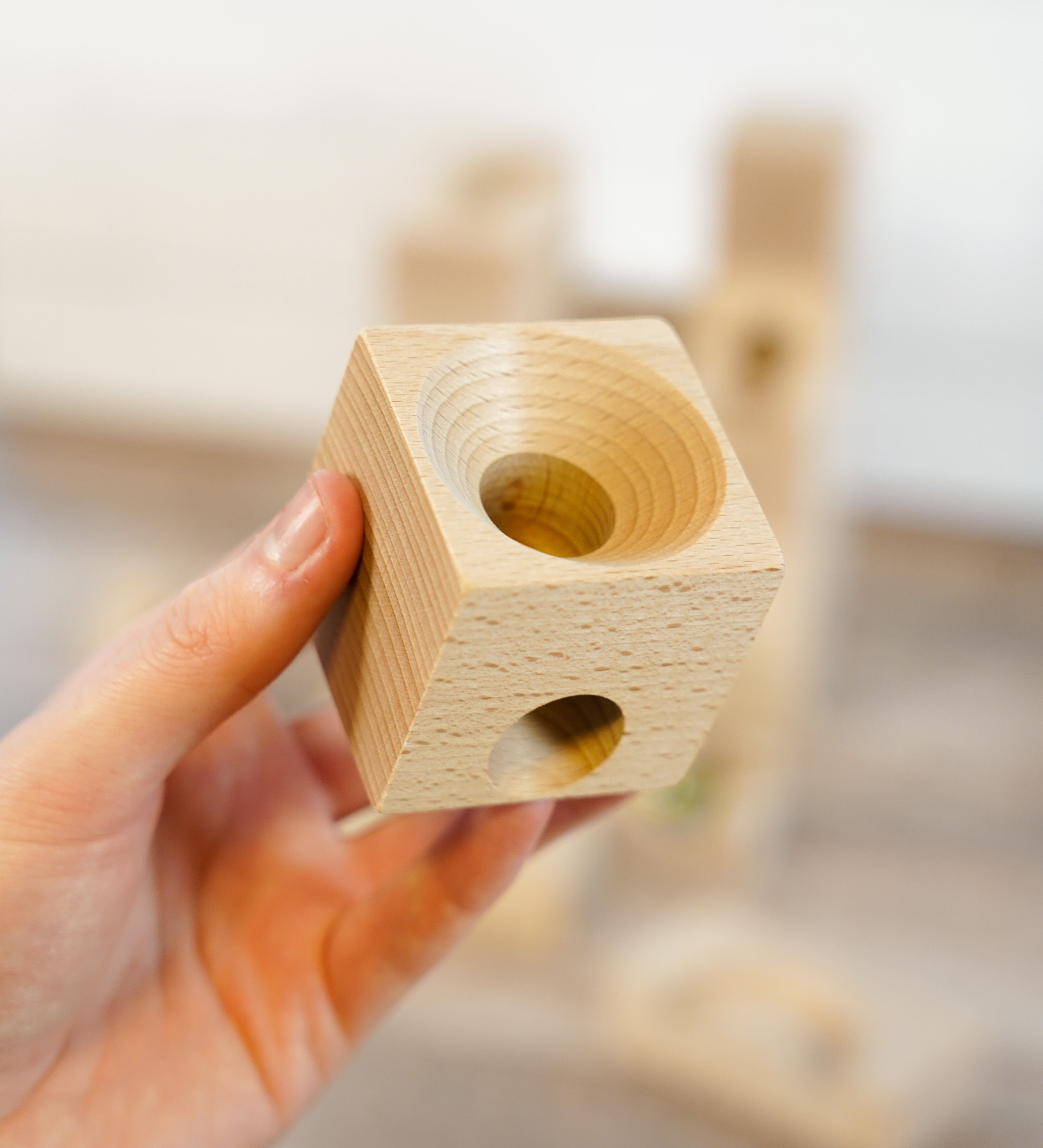 A close up of a wooden block from a Cuboro wooden marble set.