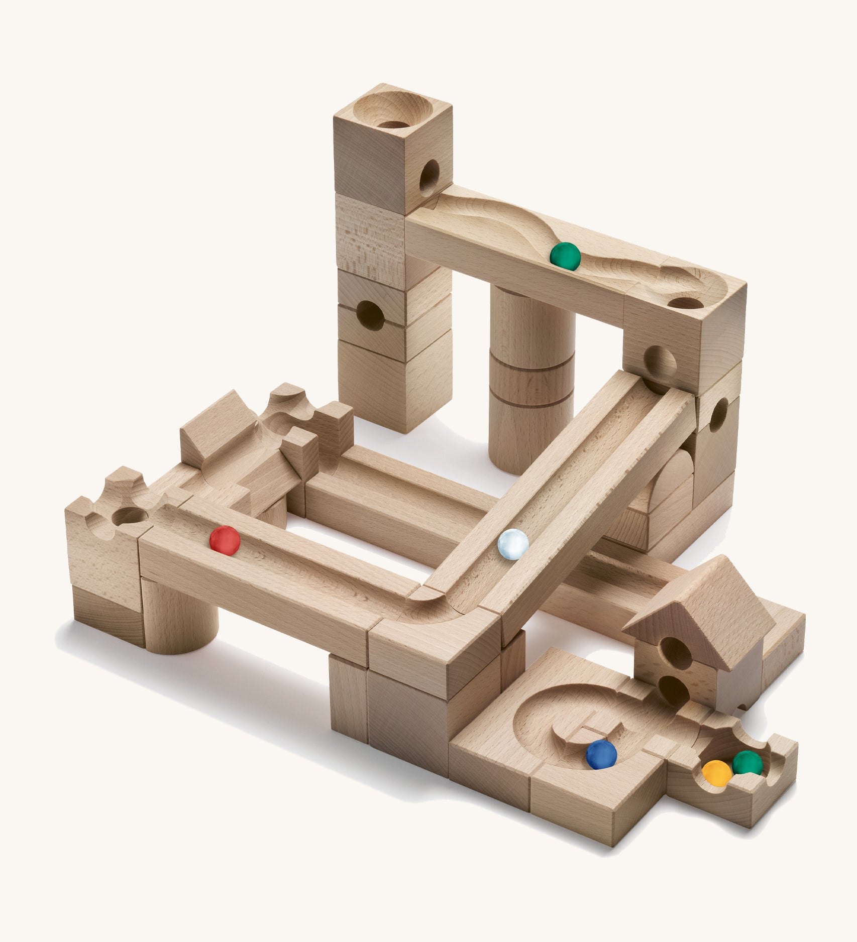 Cuboro wooden marble run junior set built into a geometric marble run on a cream background