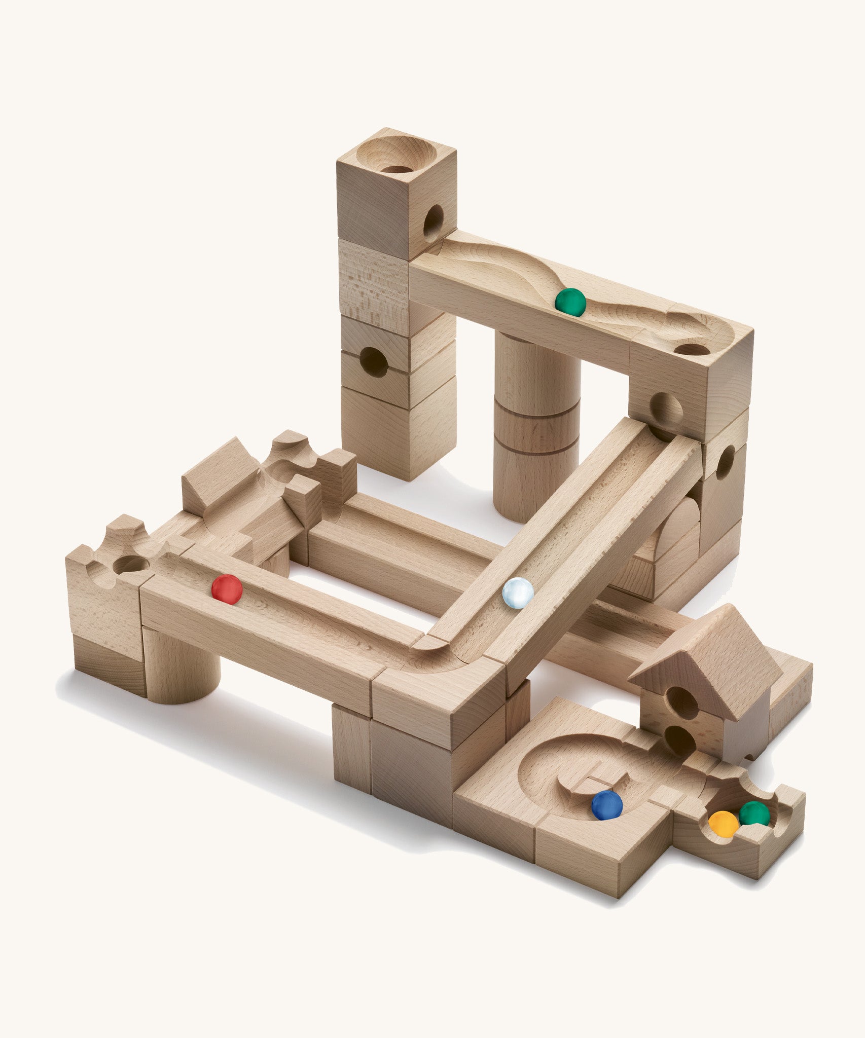 Cuboro wooden marble run junior set built into a geometric marble run on a cream background