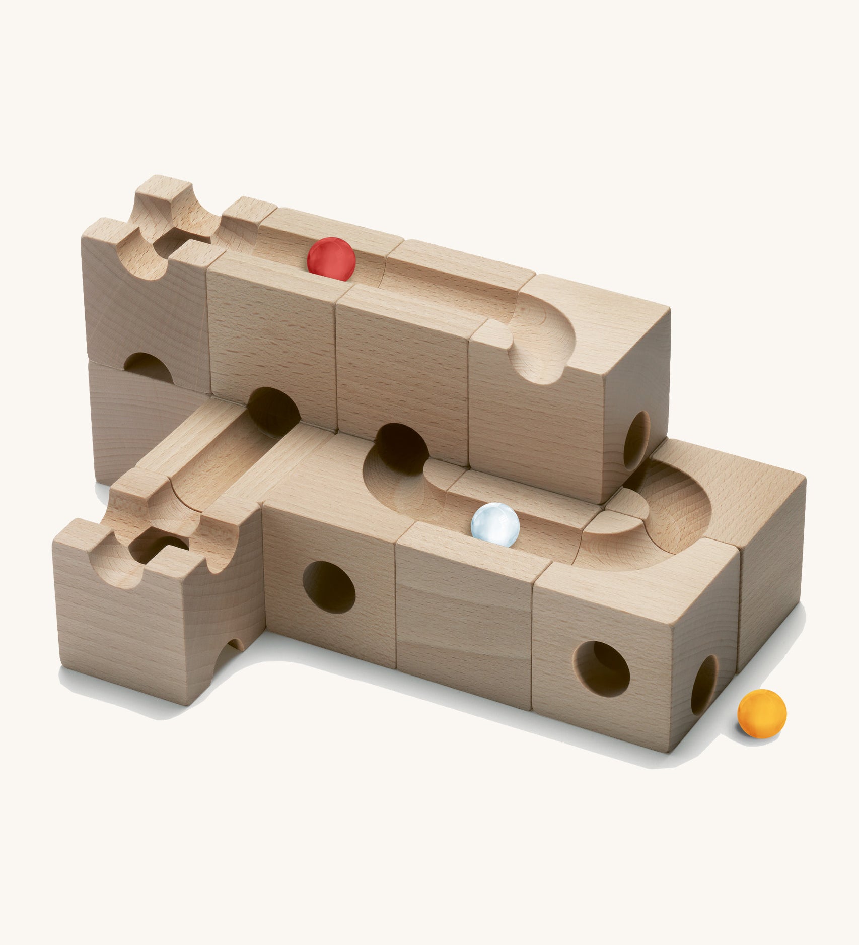 Cuboro children's pro wooden marble run toy blocks stacked on a cream background