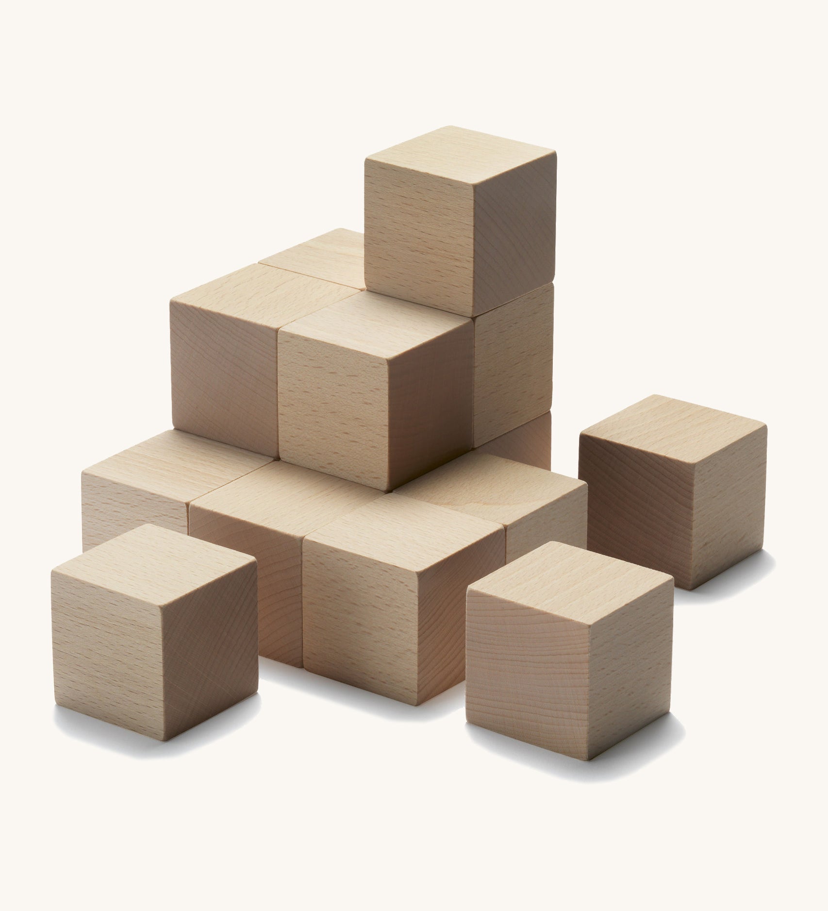 Cuboro plastic-free kids stacking marble run cubes set laid out on a cream background