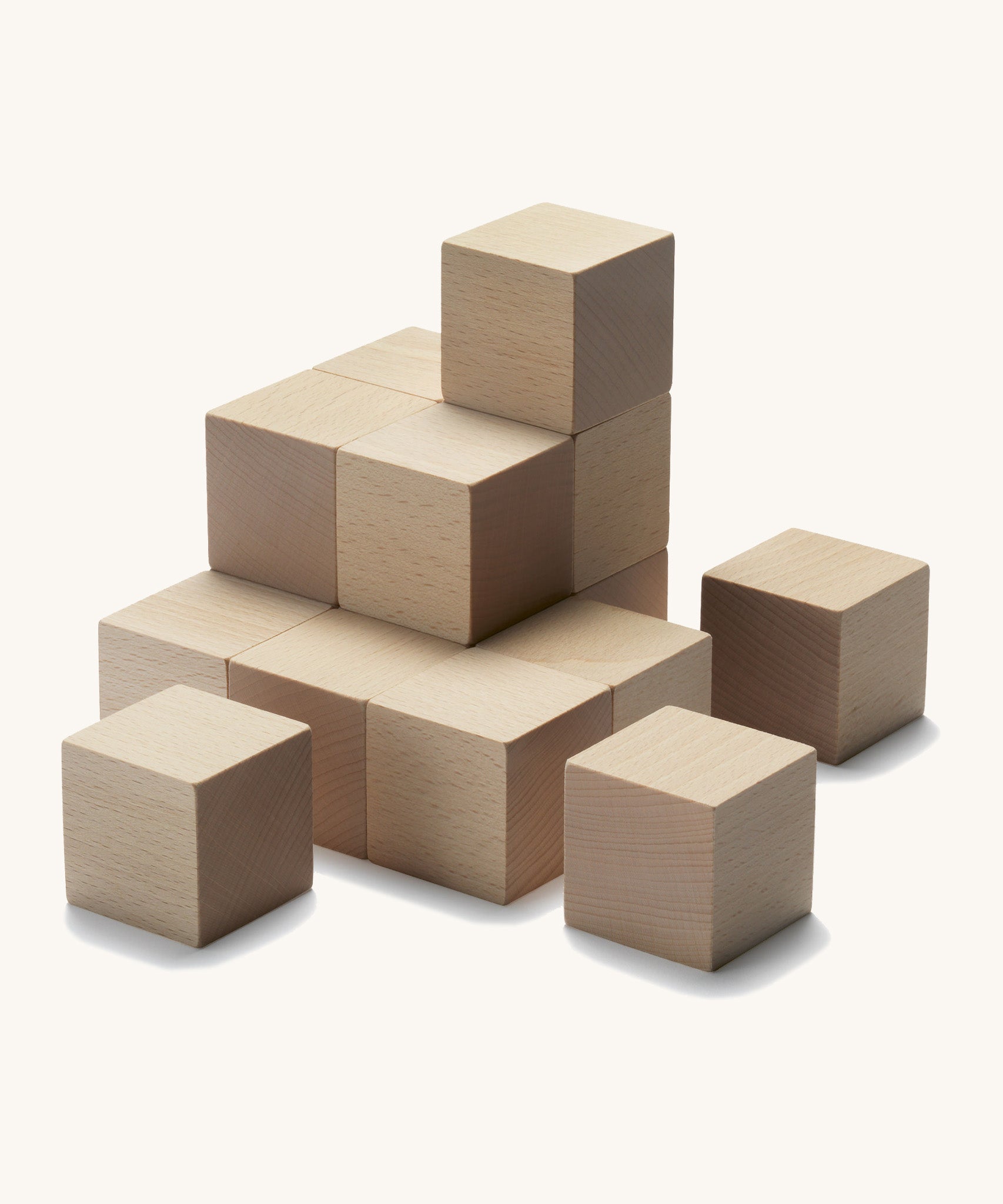 Cuboro plastic-free kids stacking marble run cubes set laid out on a cream background