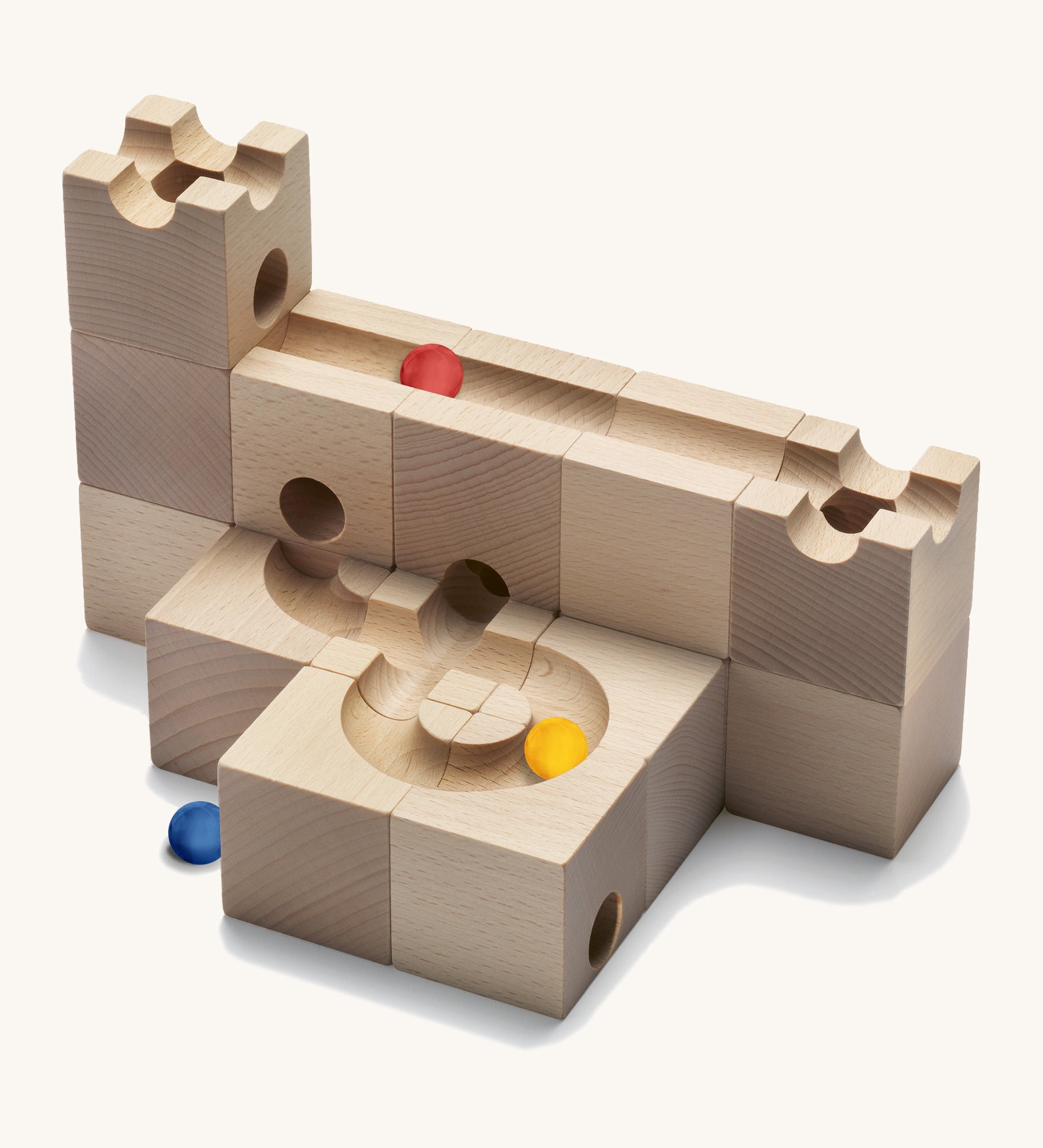 Cuboro Standard 16 piece wooden marble run building kit stacked on a cream background