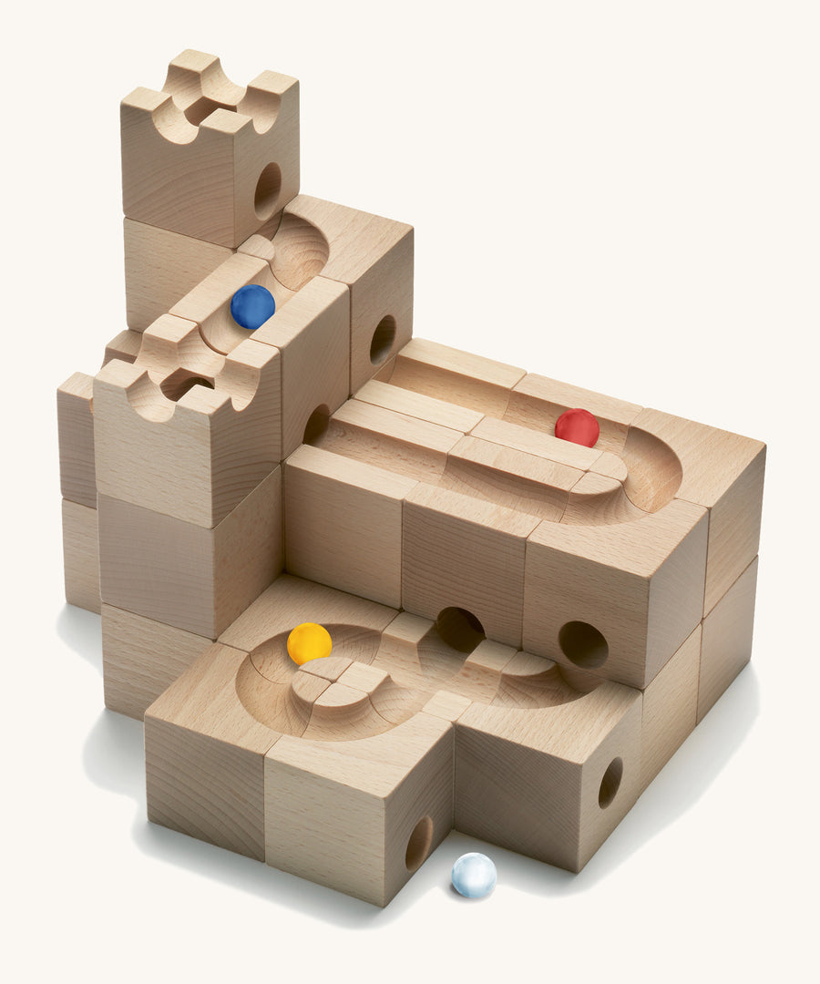 Cuboro Standard 32-piece wooden marble run building blocks stacked on a cream background