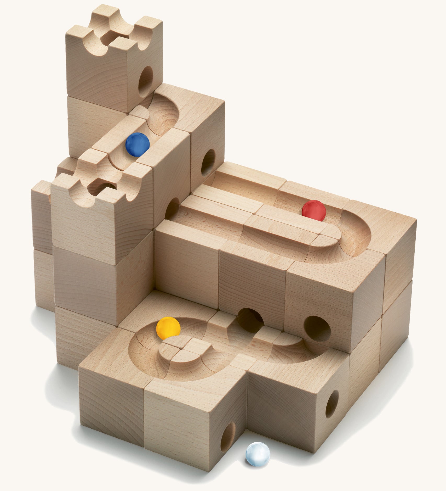 Cuboro Standard 32-piece wooden marble run building blocks stacked on a cream background