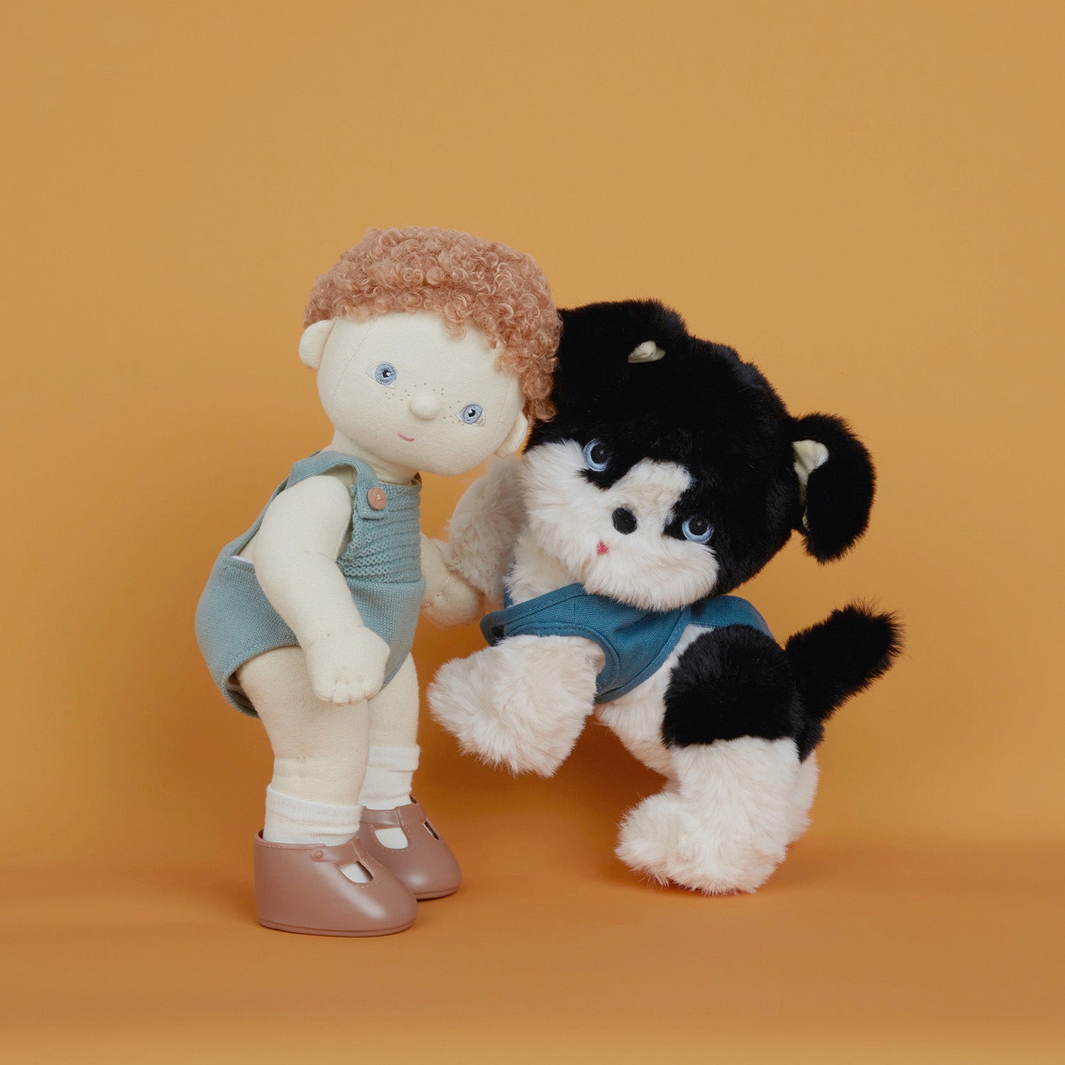 The Olli Ella Dinkum Dog "Lucky" is a dog shaped stuffed toy with soft black and white fur