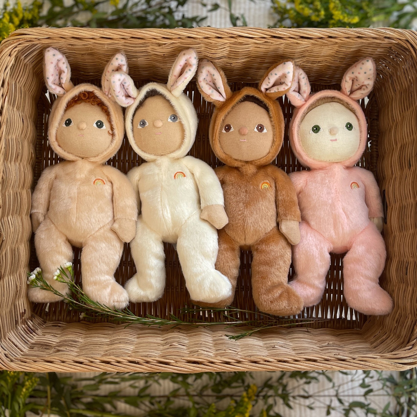 4 of the Olli Ella cream  Bunny Dinky Dinkum Dolls laying in a rectangular shaped basket.