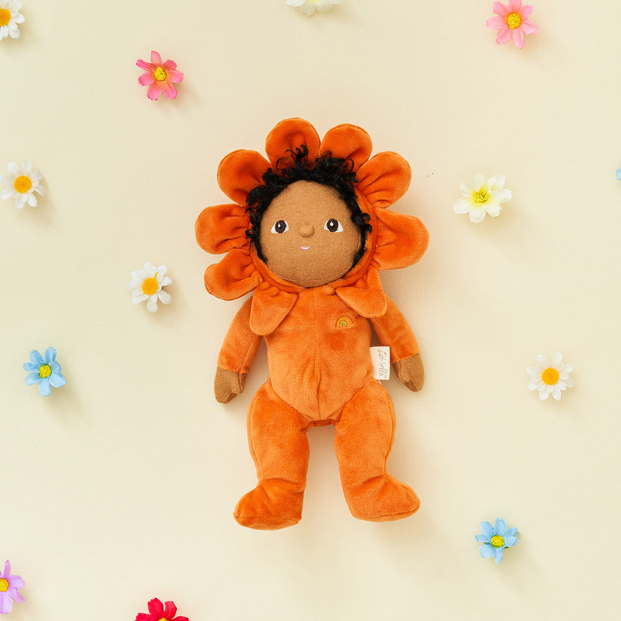 brown curly hair and brown eyes. Surrounded by the other Blossom Buds Dolls On a cream and flower back ground