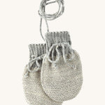 Disana organic merino wool baby mittens in grey and natural colour on a cream background.