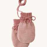 Disana organic merino wool baby mittens in rose and natural colour on a cream background.