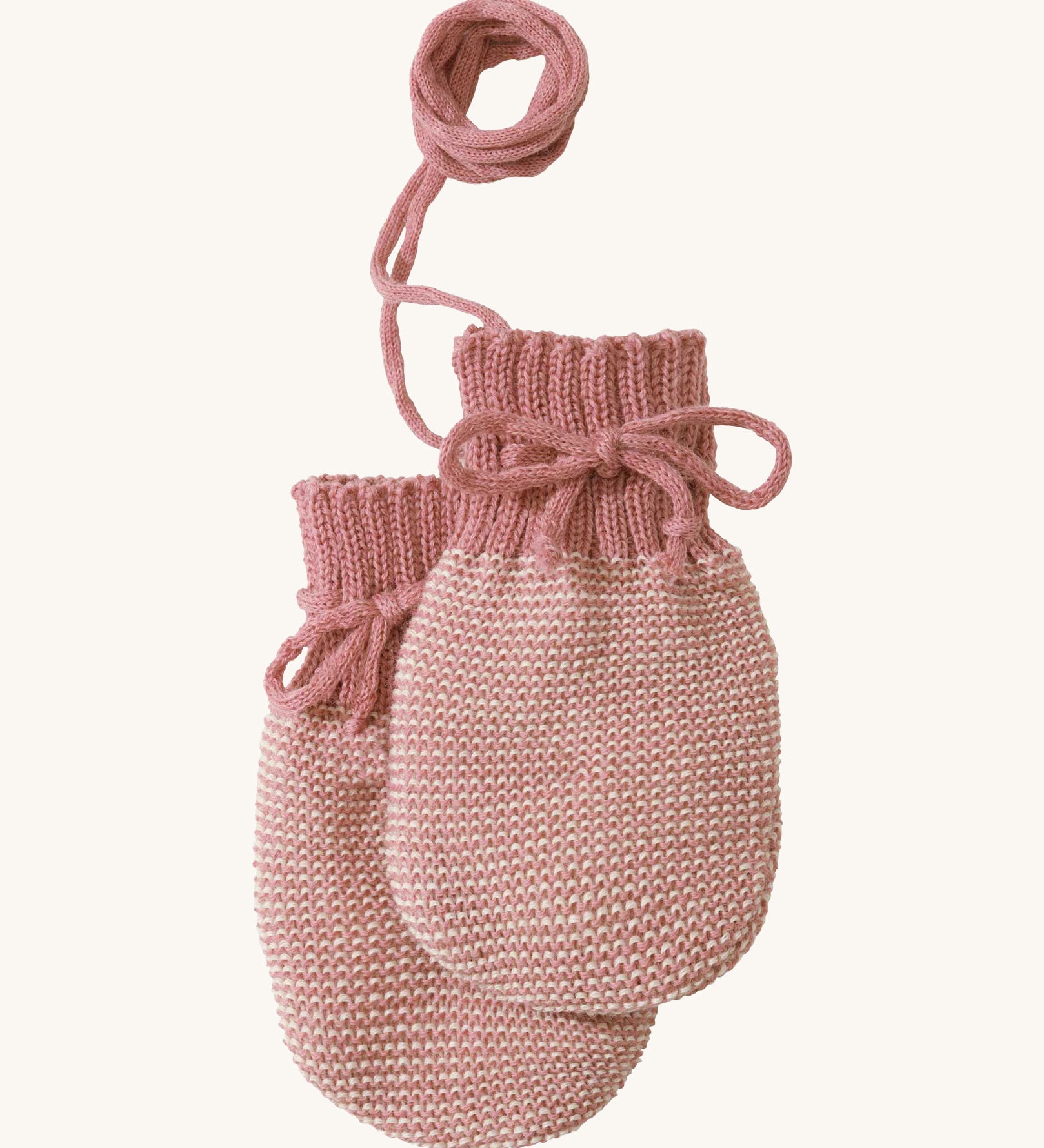 Disana organic merino wool baby mittens in rose and natural colour on a cream background.