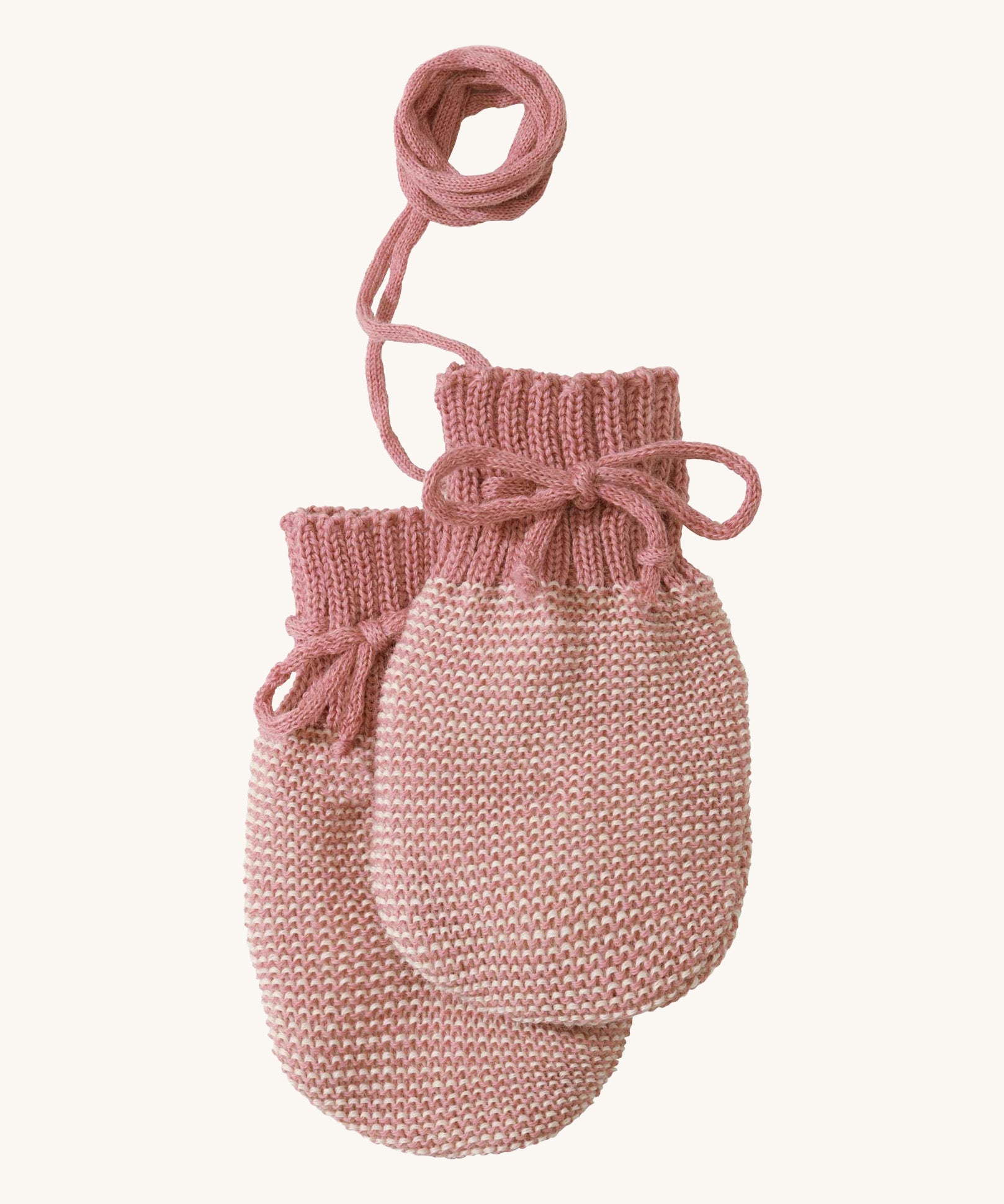 Disana organic merino wool baby mittens in rose and natural colour on a cream background.