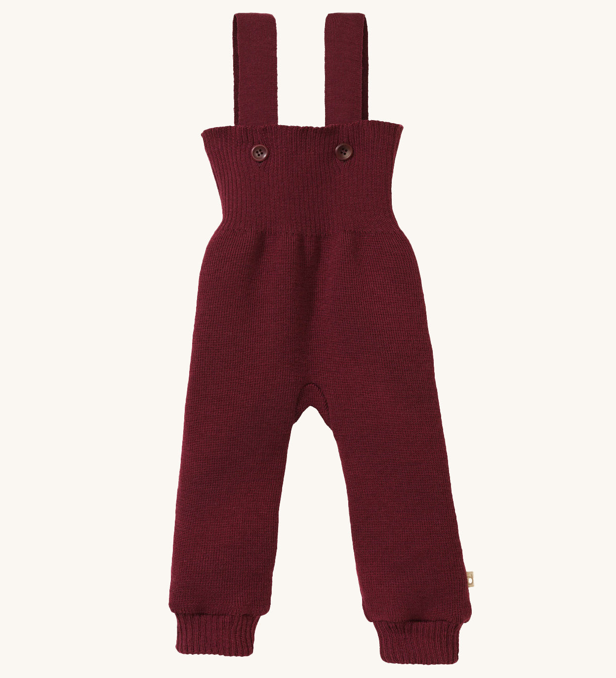 Disana organic merino wool dungarees in dark purple on a cream background.