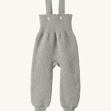 Disana organic merino wool dungarees in grey on a cream background.