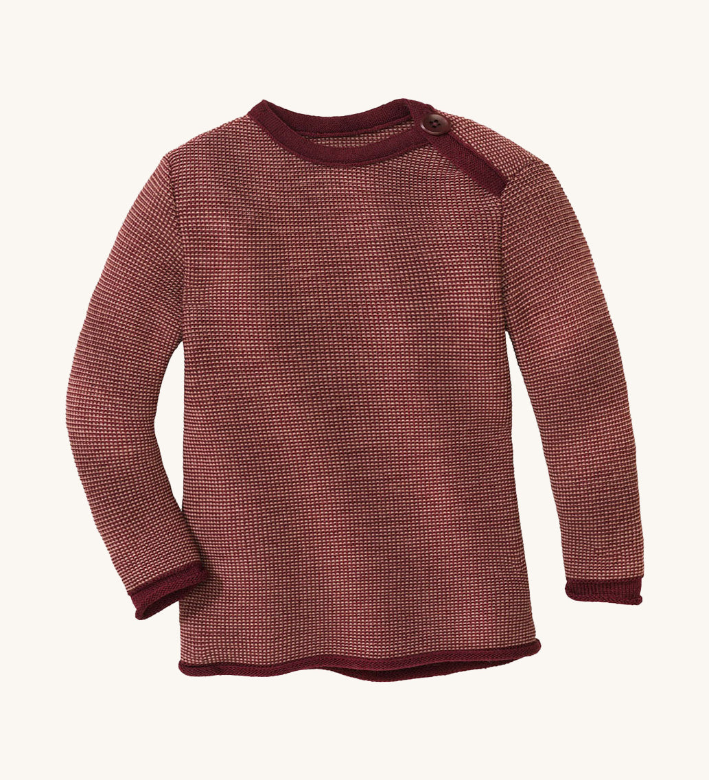 Disana organic merino wool melange jumper in a dark red colour on a cream background.