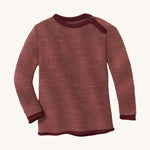 Disana organic merino wool melange jumper in a dark red colour on a cream background.